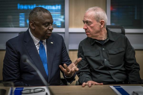 U.S. Secretary of Defense Lloyd Austin, left, speaks with Israeli Defense Minister Yoav Gallant, right, prior to a meeting with the Israeli War Cabinet at Nevatim Air ba<em></em>se, on Oct. 13, 2023 Tel Aviv, Israel. 