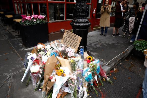 Dozens of flowers fans left by fans in wake of Matthew Perry's death outside the apartment featured on 