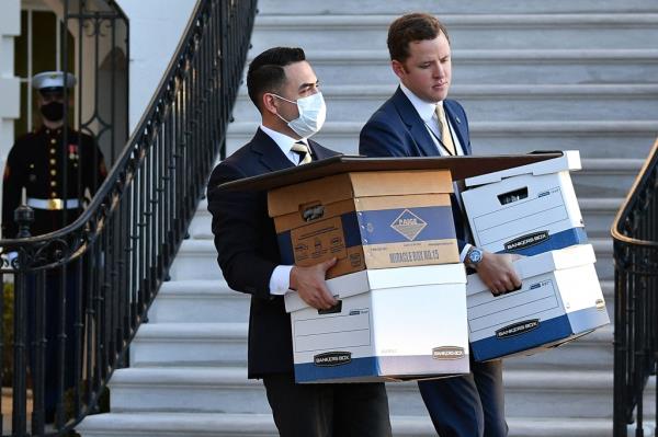 photo shows aides carrying boxes to Marine One before US president Do<em></em>nald Trump and wife Melania Trump departed from the White House on Trump's final day in office, in Washington, DC.