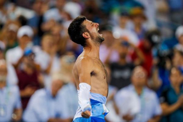 Novak Djokovic rips his shirt after winning the Cincinnati Open. 