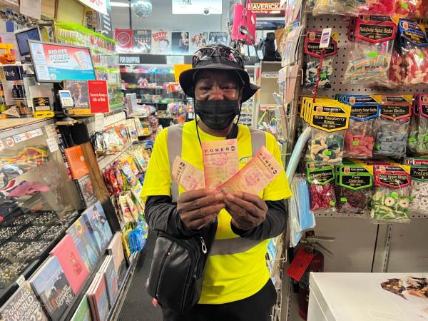 Chevy Johnson, a resident of Broward County, Fla., holds the three Powerball tickets she purchased in the hope of winning the jackpot of over $1 billion, in Fort Lauderdale, Fla., on Monday, Oct. 2, 2023.