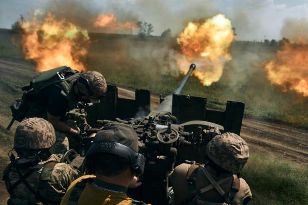 Ukrainian soldiers fire a cannon near Bakhmut.