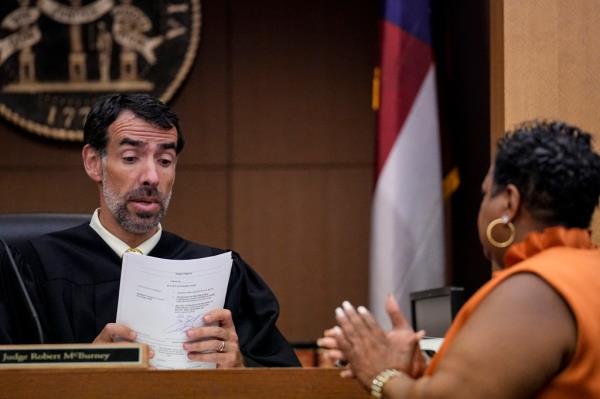 County Clerk Che Alexander, right speaks with Fulton County Superior Court Judge Robert McBurney.