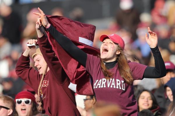 Harvard students in school merchandise