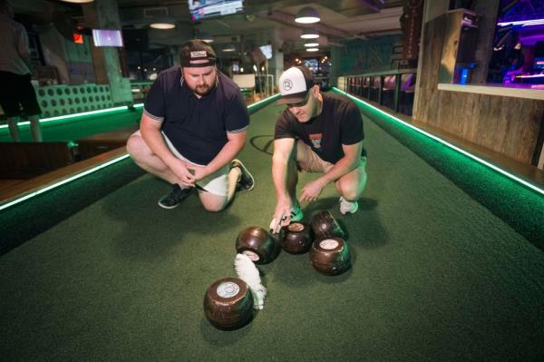 Reporter Alex Mitchell scores his first ever feather bowling point by landing closest to the pin.