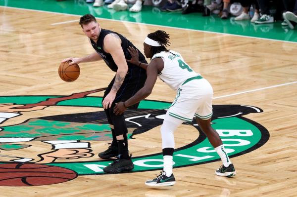 Luka Do<em></em>ncic #77 of the Dallas Mavericks drives to the basket against Jrue Holiday #4 of the Boston Celtics during the fourth quarter in Game One of the 2024 NBA Finals at TD Garden on June 06, 2024 in Boston, Massachusetts. 