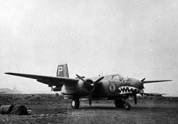 A-20G 'Barry's Baby I.N.S.' aircraft with shark face motif, parked at Nadzab Airfield in New Guinea, associated with 2nd Lt. Ambrose J. Finnegan and 1st Lt. Harold R. Prince