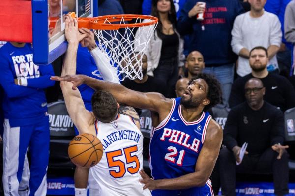 Joel Embiid #21 of the Philadelphia 76ers blocks Isaiah Hartenstein #55 of the New York Knicks 