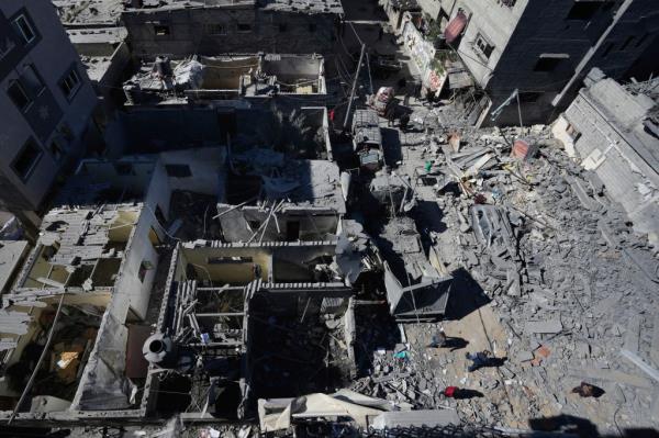 Palestinians inspect the rubble of destroyed buildings after an Israeli airstrike hit the Nusseirat refugee camp in Gaza on Thursday. 