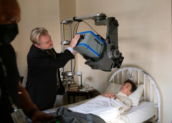 Filmmaker Christopher Nolan working with an IMAX camera on the set with actor Cillian Murphy during the filming of 