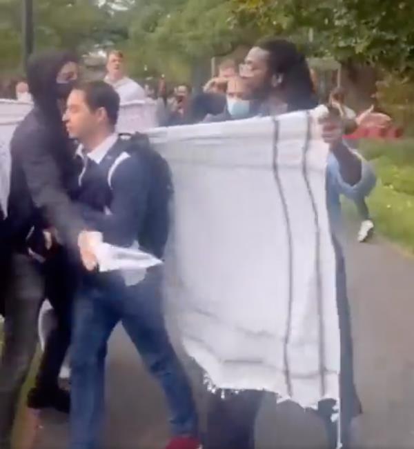 A Jewish student is pictured being surrounded on Harvard's campus as a pro-Palestine rally was taking place.