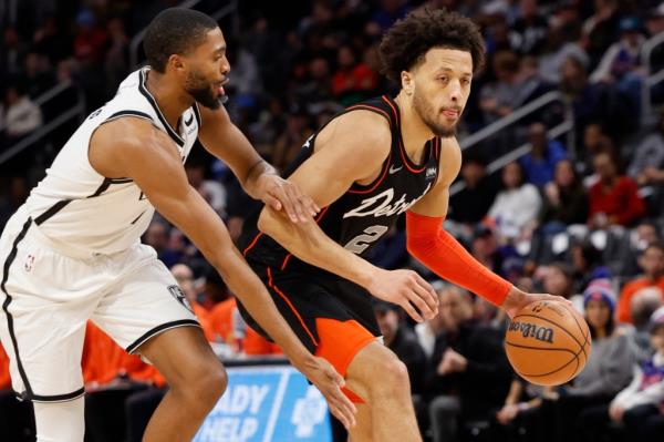 Pistons guard Cade Cunningham (2) dribbles around Brooklyn Nets forward Mikal Bridges (1) in the first half on Tuesday.