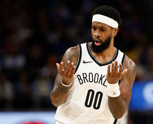 Royce O'Neale of the Nets looks at his hands after sinking a 3-point shot against the Detroit Pistons