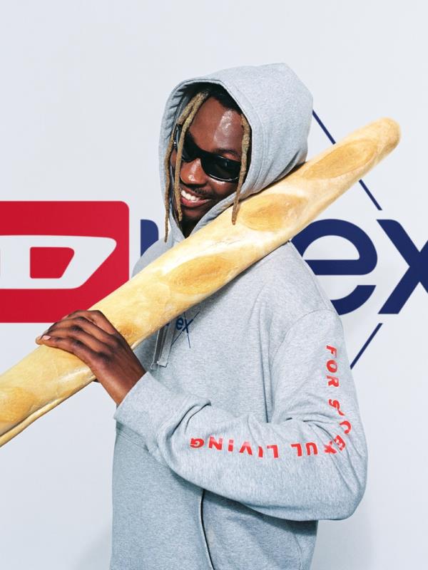 Model in diesel sweatshirt holding bread