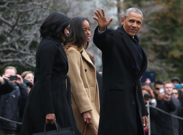 Barack Obama waves as he walks with Michelle Obama and daughter Malia toward Marine One while departing from the White House on Jan. 10, 2017, in Washington, DC. 