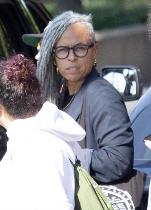 Shellyne Rodriguez outside Bronx Supreme Court in NY wearing glasses, staring into camera.