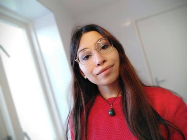 Liana Pereira in a red jumper and glasses