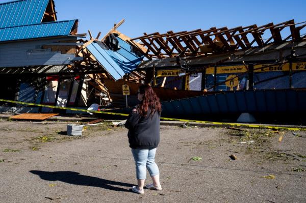 Jennifer Cory surveys businesses and buildings severely damaged after a tornado hit the area of Portage, Michigan, U.S., May 8, 2024. 