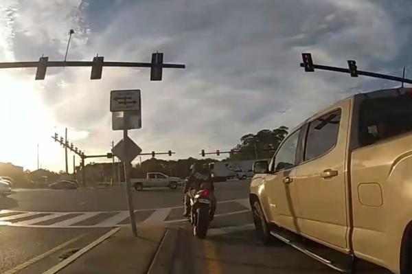 A mullet-sporting motorcyclist whose license plate reads 