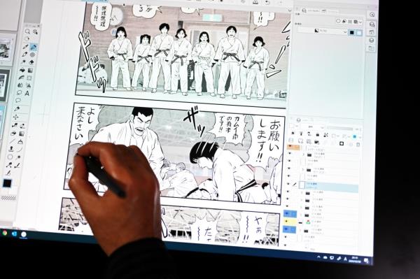 In this picture taken on March 6, 2020, Japanese manga artist Makoto Kobayashi works on his judo manga series on a computer screen in Tokyo.