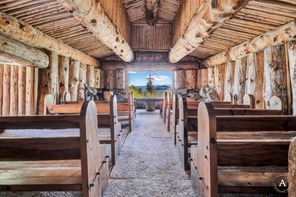 The chapel, with wood-heavy details, also has a choir loft.