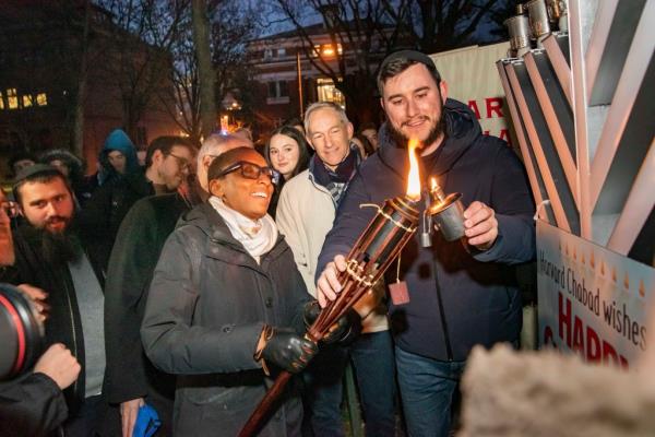 Claudine Gay lights menorah