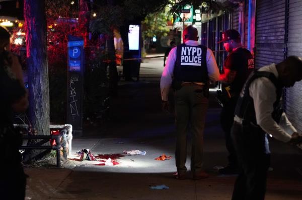 Police at the scene wher<em></em>e two people were shot on Third Avenue at E111th Street in New York City. 