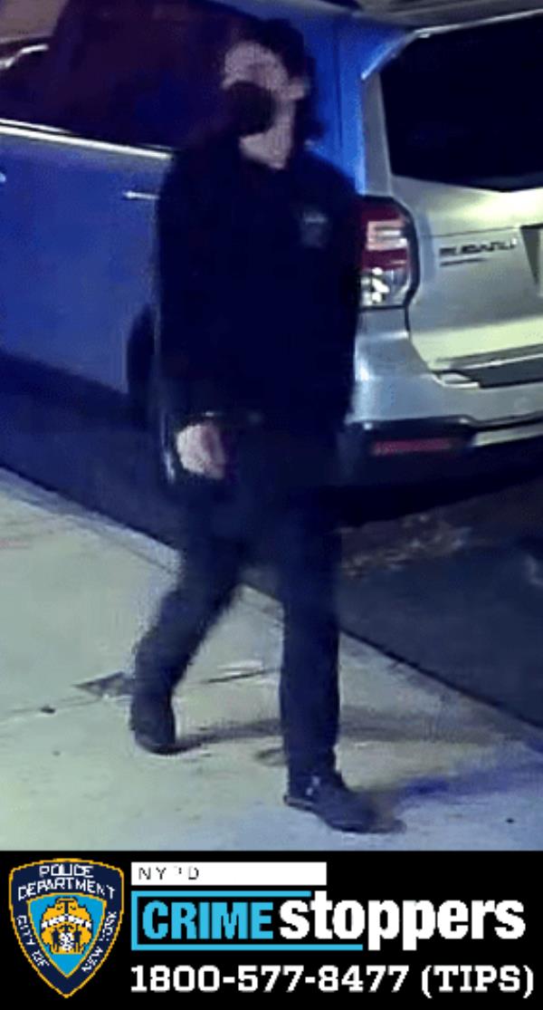 One of the five masked suspects wanted in the destruction of the building.