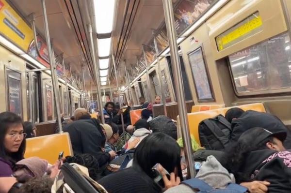 A photo of straphangers taking cover