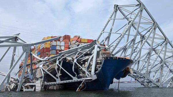 Part of a span of the collapsed Francis Scott Key Bridge is suspended on the co<em></em>ntainer ship Dali in Baltimore, Maryland, U.S., March 26, 2024.