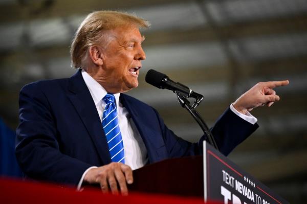 Do<em></em>nald Trump speaking into a microphone at a campaign event in Las Vegas, Nevada.