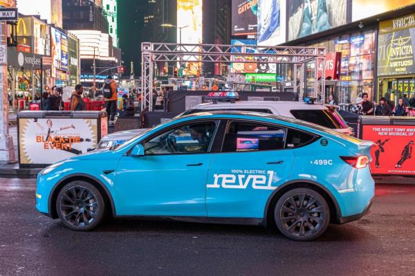 An electric revel brand car in Times Square