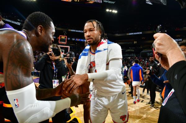 Julius Randle #30 of the New York Knicks hands off the game ball from Jalen Brunson's 50-point game against the Phoenix Suns.