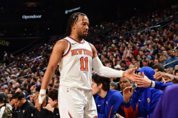 Jalen Brunson #11 of the New York Knicks walks towards the bench during the game against the Phoenix Suns on December 15, 2023