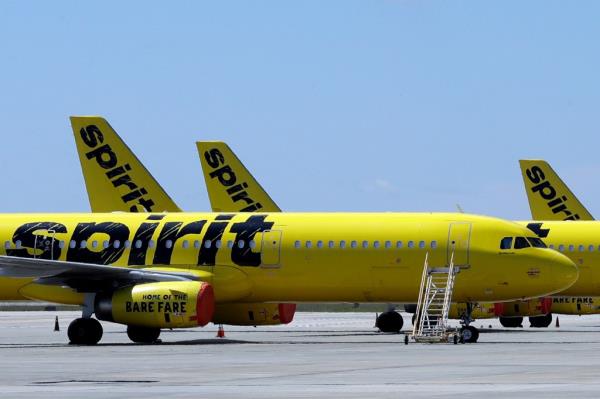 A line of Spirit Airlines jets sit on the tarmac at Orlando Internatio<em></em>nal Airport.