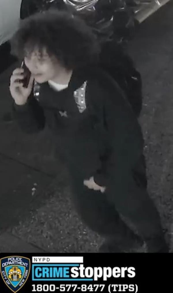 One of the teen suspects is seen wearing all black, wearing a backpack and talking on the phone.