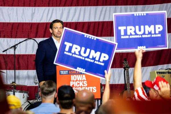 Republican presidential candidate Florida Gov. Ron DeSantis looks into the crowd after speaking as supporters of former President Do<em></em>nald Trump hold up signs during the Ashley's BBQ Bash fundraiser, Sunday, Aug. 6, 2023, at Hawkeye Downs in Cedar Rapids, Iowa.