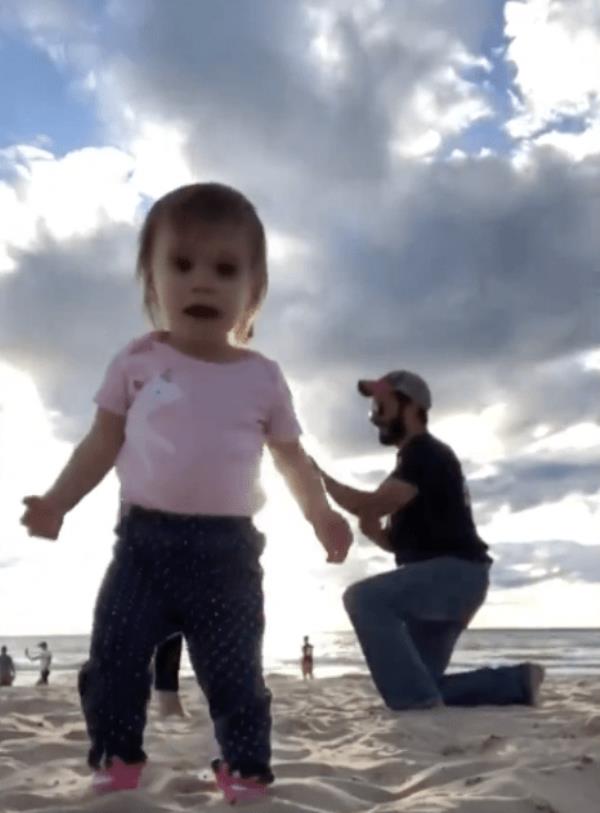 An adorable little girl crashed her parents' sunset engagement video.