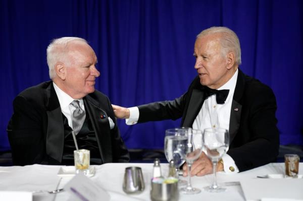 President Joe Biden talks with John F. Lansing, President and CEO of NPR, during the White House Correspondents' Association dinner at the Washington Hilton in Washington, Saturday, April 29, 2023. 