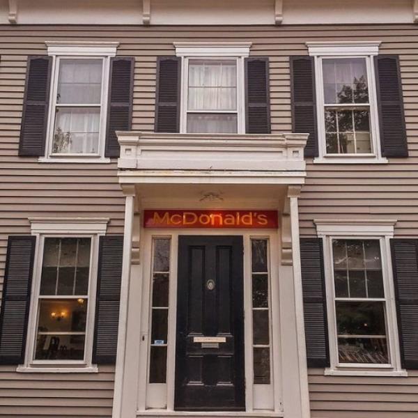 A muted McDonald's sign hangs above doorway of the Colo<em></em>nial style mansion.