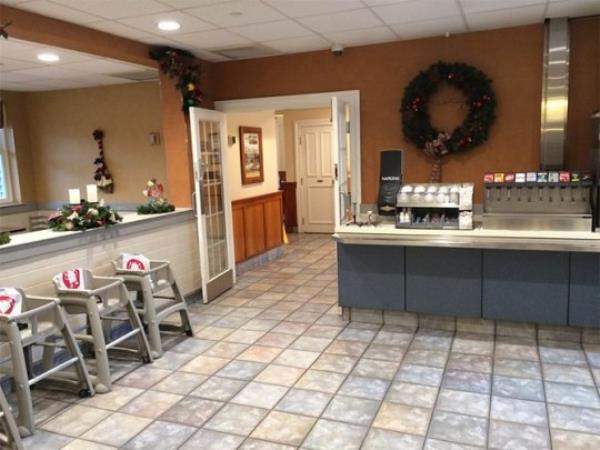 Inside the restaurant are high chairs and coca cola machines.