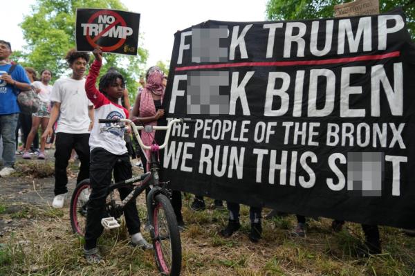 A sign protesting Trump and Biden at the rally.