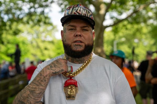 A Trump supporter showing off a necklace with the former president's face.