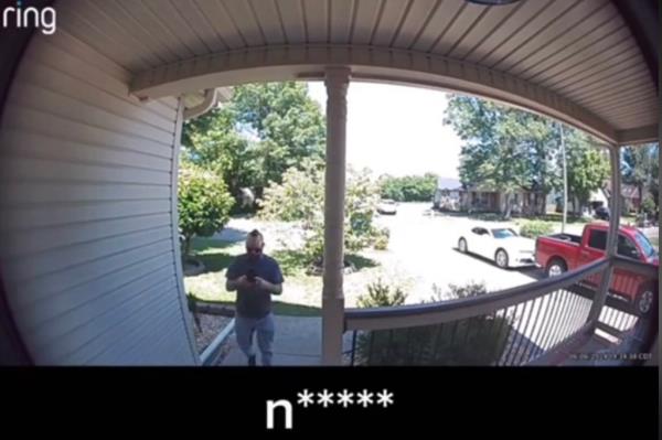 DoorDash driver on phone behind porch.