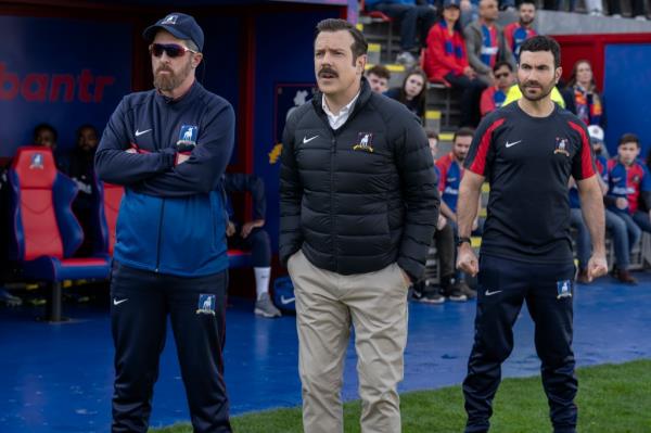 Jason Sudekis standing on a soccer field. 