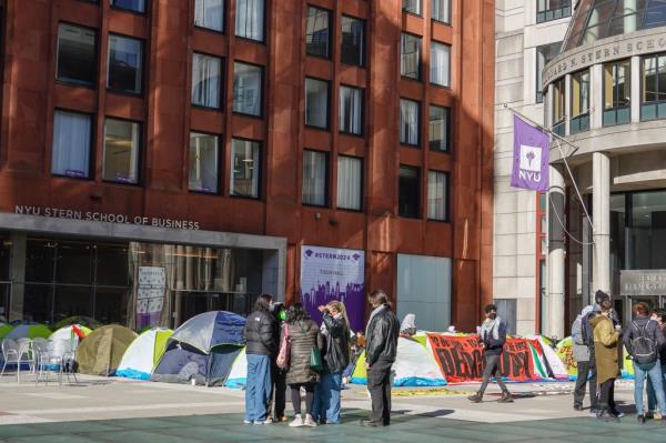 Dozens of tents were seen being set up in front of the business school on Monday.