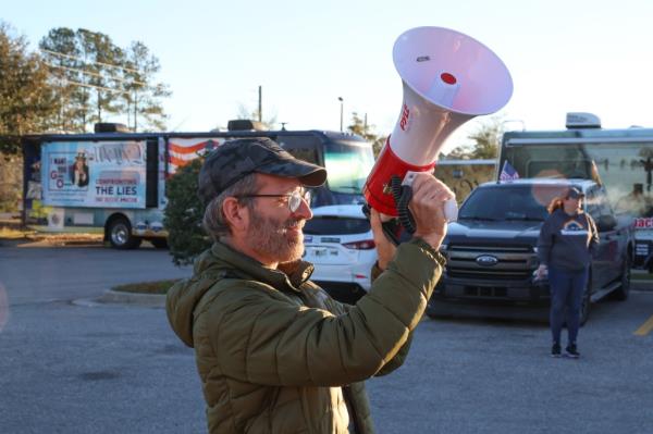 A man with a bullhorn. 