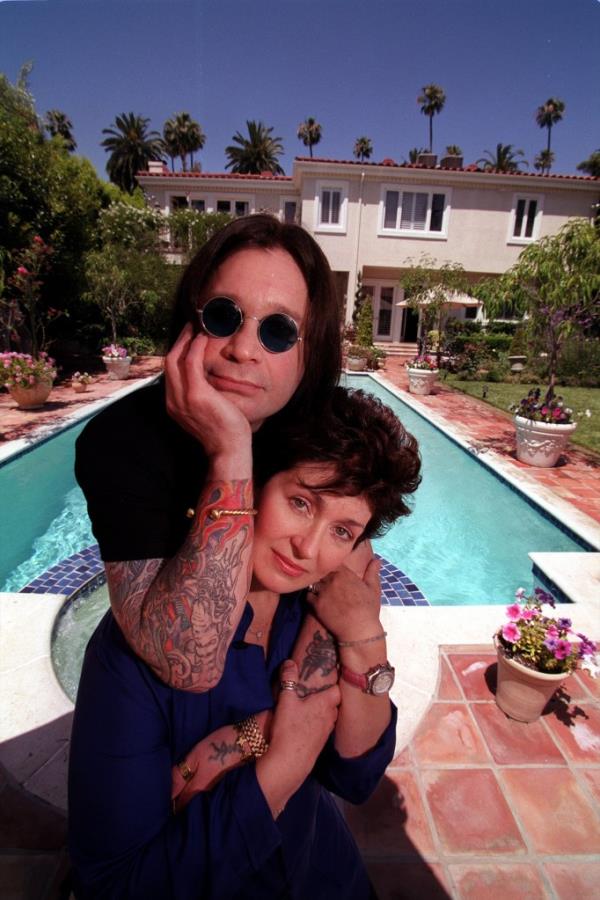 Ozzy and Sharon Osbourne pose outside their Beverly Hills home.