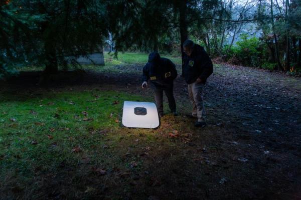 This image provided by Kelly Bartlett shows passengers near a hole in the fuselage of an Alaska Airlines Boeing 737 Max 9, Flight 1282 on Jan. 5, 2024. 