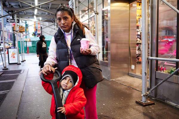 Wendy Parra, 23, a migrant from Ecuador, and her son outside the Row Hotel shelter